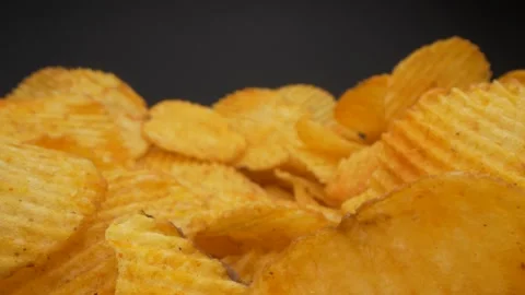 Slider view of camera coming to spicy chips. Man takes chips. Unhealthy snacks Stock Footage 153620083
