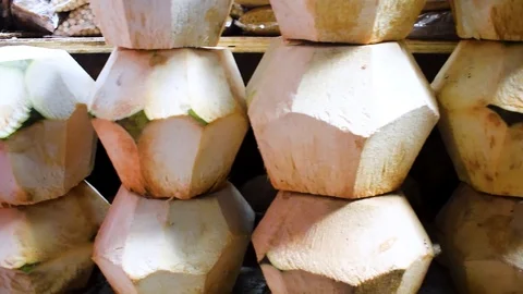 Slider view of half skinned coconut perfectly stacked into three layers Stock Footage 101968825