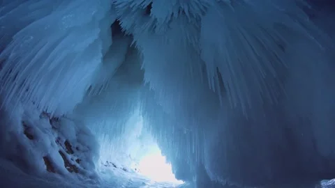 Slider winter ice cave sharp icicles splashing Frozen ice floe lake Baikal Stock Stock Footage 165664025