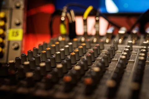 Sliders and knobs at an audio mixing console. Stock Photos