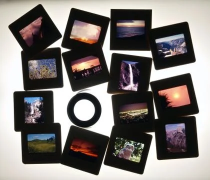 Slides and lupe on light table Stock Photos