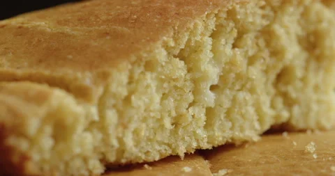 Sliding on baked piece of cornbread 4K sliding footage Stock Footage 251999967