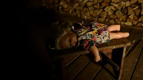 Sliding beam of light gradually illuminates the doll lying on the bench Stock Footage 120247252
