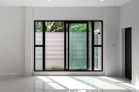 Sliding black stainless steel glass doors inside the house. Stock Photos