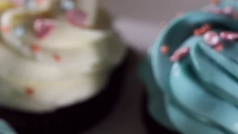 Sliding camera shooting. Close-up of blue and white cream on mafin. Icing sugar Stock Footage 77037547