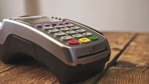 Sliding card through POS terminal and entering amount Stock Footage 132428795