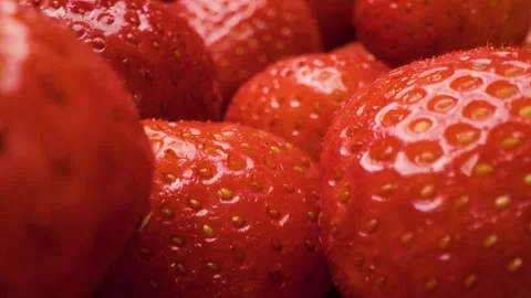 Sliding close-up of ripe strawberries in sharp detail. Stock Footage 313802436