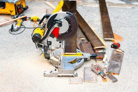 Sliding Compound Miter Saw and Flooring Wood Planks Outdoors Stockfoto's