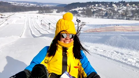 Sliding down by hill on snow tubes Stock Footage 162776478