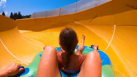 Sliding down the slide in the aqua park, mum and daughter Video stock 91102461