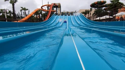 Sliding down a waterslide in slow motion Video stock 107369813
