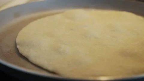 Sliding on flat bread on pan 4K video Stock Footage 150912056