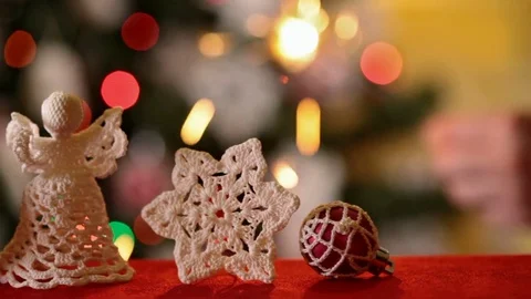 Sliding in front of christmas ornaments while a hand lights a sparkler Video stock 81133723