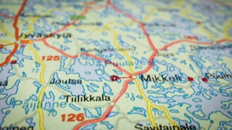 Sliding macro shot over map showing lakes and road network in Finland Stock Footage 332798021