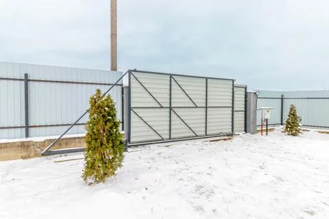 Sliding Metal Gate with Automatic Opening, Winter, Snow 스톡 사진