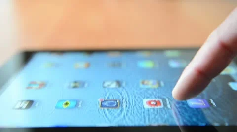 Sliding program icons on a touchscreen of Apple iPad New device Stock Footage
