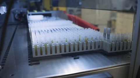 Sliding samples into a medical sampling machine looking for a cure to a virus Stock Footage 127532784