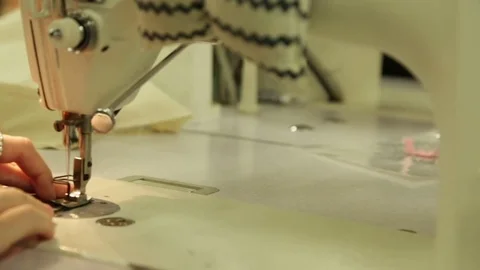 Sliding shot of Hands using sewing machine in clothing factory 動画素材 72671261