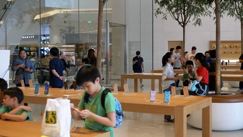 Sliding shot of kids checking out phones at the apple store in icon Siam Stock Footage 105569866
