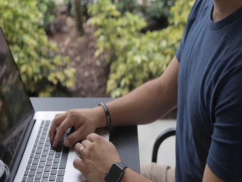 Sliding Shot of Man on Computer Close Up Outdoor Видео 80607660