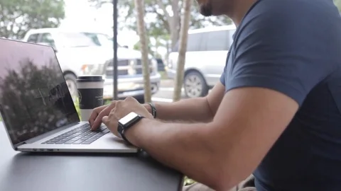 Sliding In Shot of Man on Computer Close Up Outdoor Видео 80607661