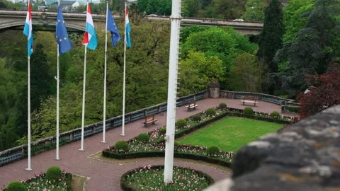 Sliding shot with panoramic view of the Flags of Luxembourg Stock Footage 277990166