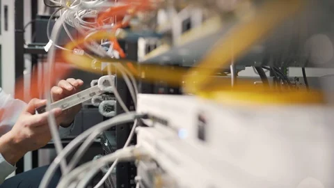 Sliding shot of a technician inserting a board into a fiber optic server Stock Footage 114193335
