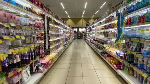 Sliding shot through the empty aisles of the supermarket with offers and 動画素材 200111750