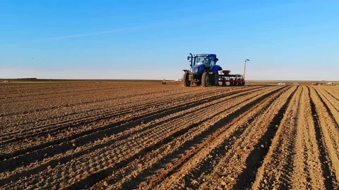 Sliding shot of tractor seeding Stock Footage 88900682