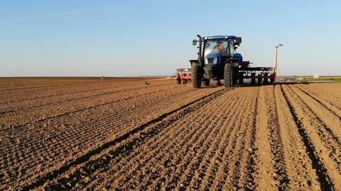 Sliding shot of tractor seeding Stock Footage 104083950