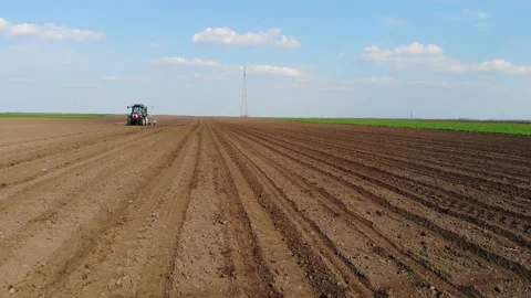Sliding shot of tractor seeding Stock Footage 130636692
