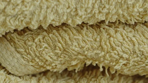 Sliding by stack of yellow towels 4K video Stock Footage 188782057