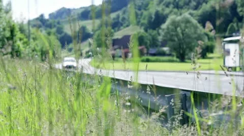 Sliding through grass on road vehicles driving Stock Footage 28963885