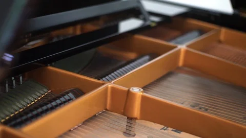 Sliding through interior of luxurious grand piano craftmanship in 4K Stock Footage 108851002