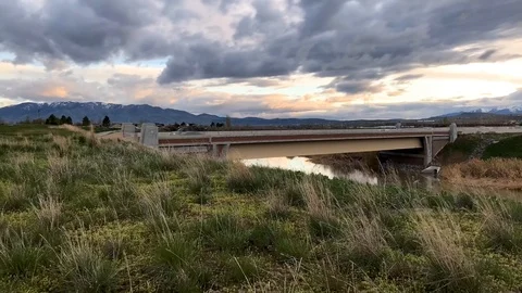 Sliding time lapse of a stormy day with mountains and highway Stock Footage 106789140