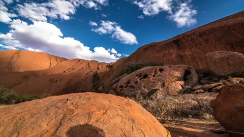 Sliding timelapse of Uluru/Ayers Rock and people passing by Stock Footage 130761319