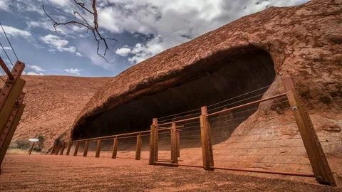 A sliding timelapse video of a cave at summit of Uluru/Ayers Rock Stock Footage 130761309
