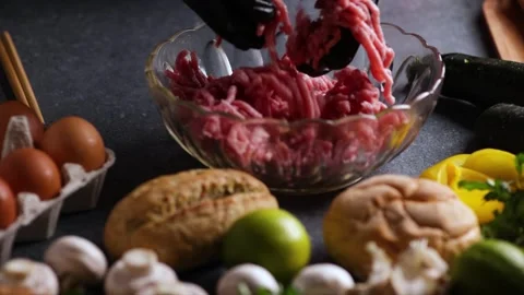 Sliding video of chef hands adding minced meat to crystal bowl with assorte.. Stock Footage 321286117