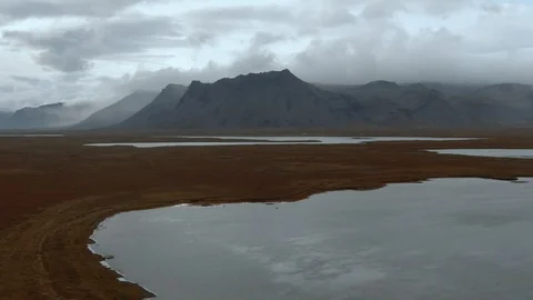 Sliding view of volcanic mountains with clouds in West Iceland Stock Footage 117348368