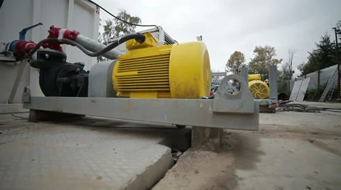Sliding view of working area with yellow motors and walking worker Stockbeeldmateriaal 36167723