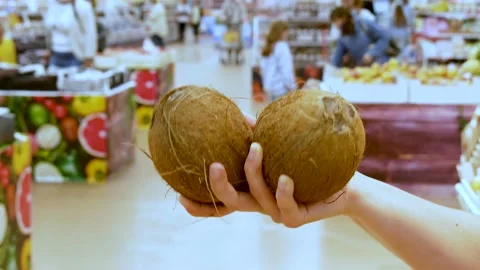 Сlient examines coconuts for freshness. Stock Footage 157536716