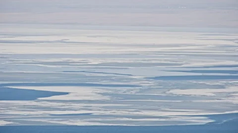 Slight Aerial View of Blue Ocean with Floating Ice Stock Footage 326424580