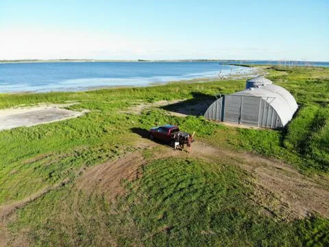 Slightly Angled Aerial Shot of Devil's Lake Farm With Lake Backdrop Stock Photos