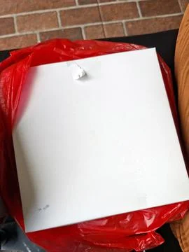 Slightly angled shot of a plain, square white cardboard box nestled inside .. Stock Photos