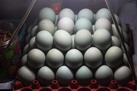Slightly angled view of stacked salted duck eggs in display cabinet with so.. Stock Photos