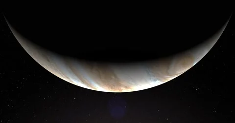 A slightly off-camera sun illuminates a crescent of Jupiter's surface. Stock-Footage 63804704