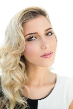 Slightly content smiling blonde model looking at camera Stock Photos