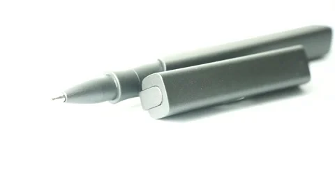 Slightly defocused and closeup of sleek black metal pen. Moving shot around. Stock Footage 41841086