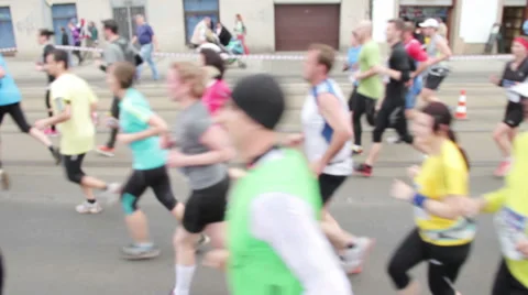 Slightly defocused side shot of people running at half Marathon event Stock Footage 36990083