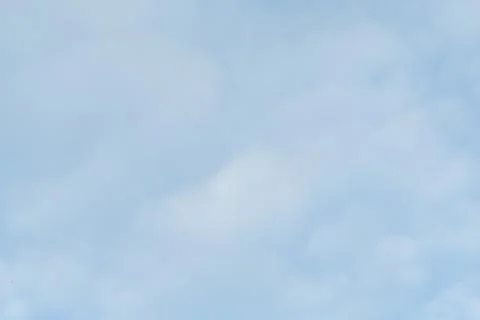 Slightly fluffy clouds on the blue sky showing white soft texture pattern Stock Photos